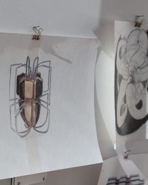 Drawings pinned to a studio wall